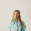 camisa_de_nia_oversize_co_3-1.webp Camisa de niña oversize con lazada azul-MINI Best Sale